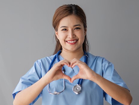 Nurse making a heart symbol with her hands