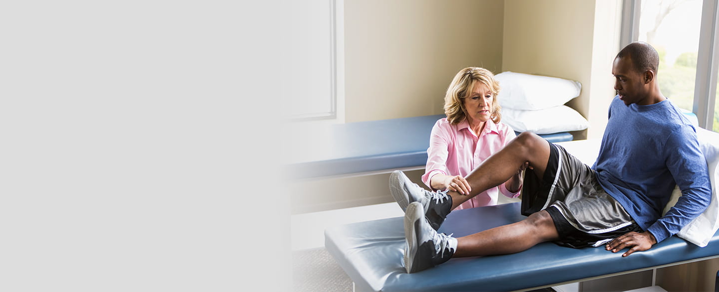 Doctor examining patient's knee.