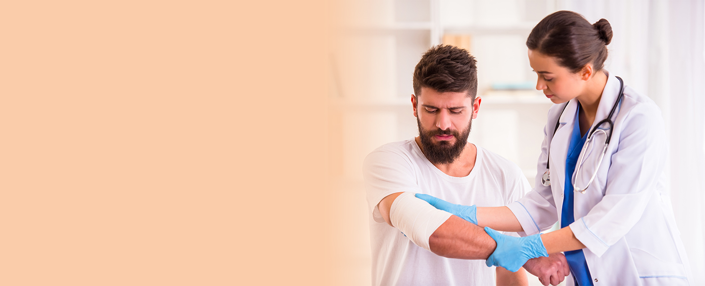 Doctor looking at arm injury.
