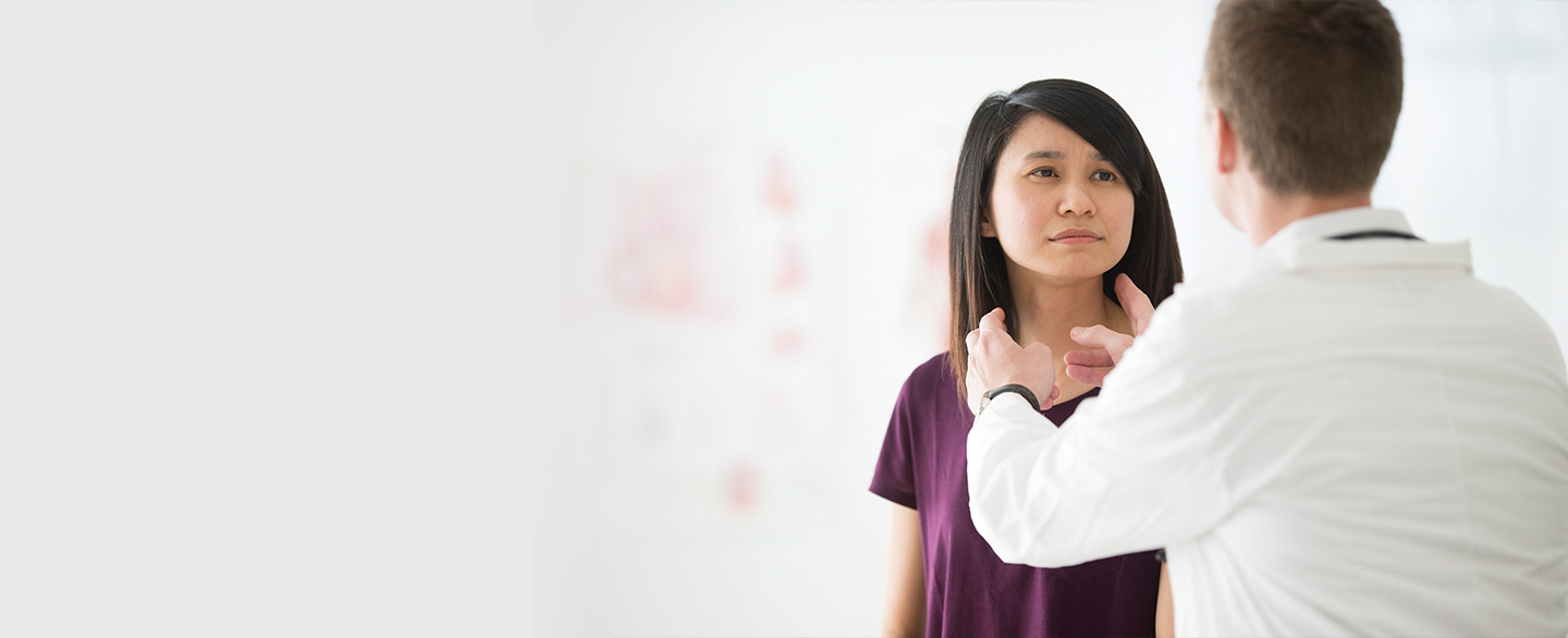 Doctor examining patients neck