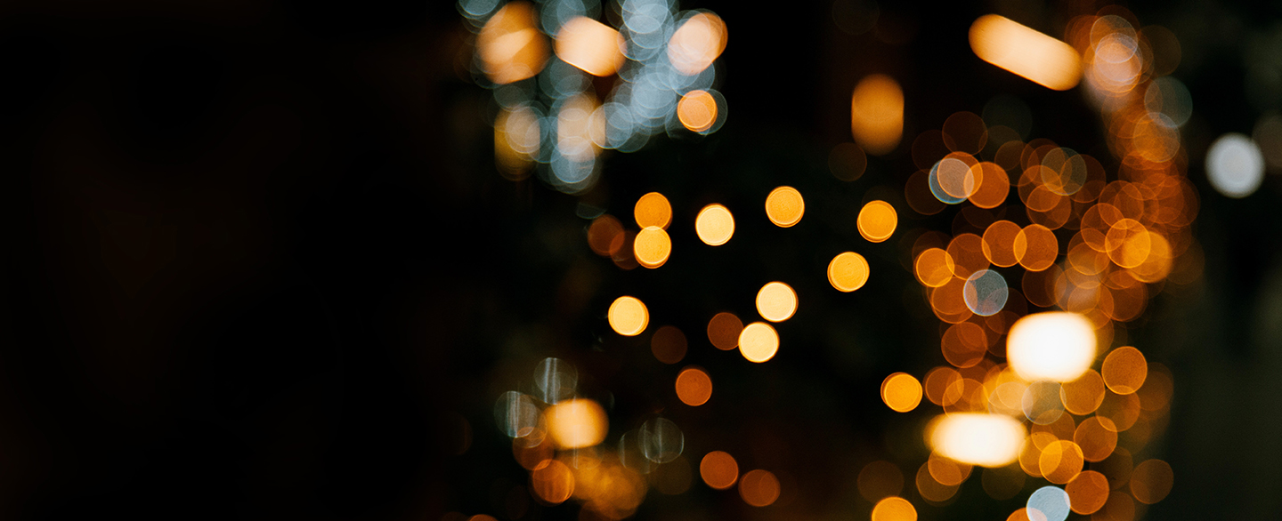 Photo of blurred gold lights against a black background
