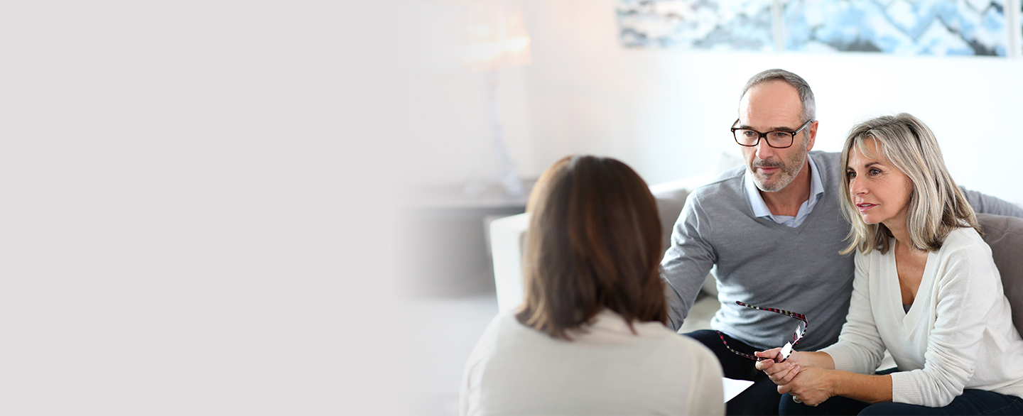 Couple meeting with a woman about finances.