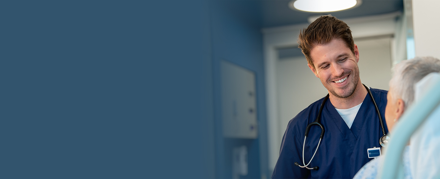 Male nurse visiting with patient.