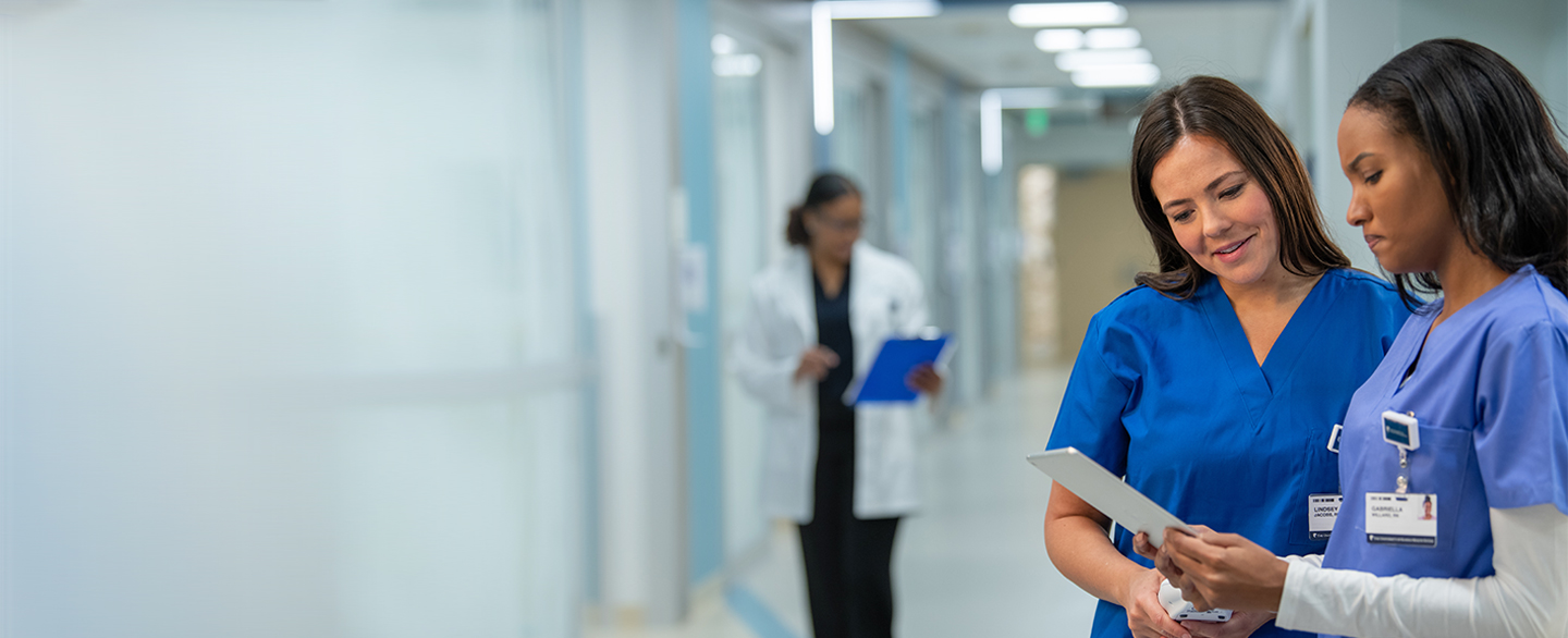 Two nurses looking at an iPad.