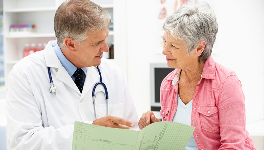 Doctor going over chart with patient.