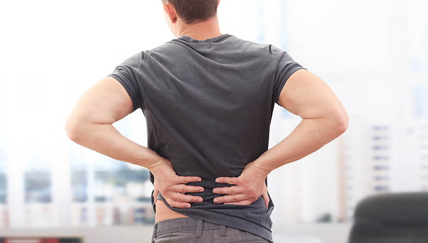 Man holding his back in pain.