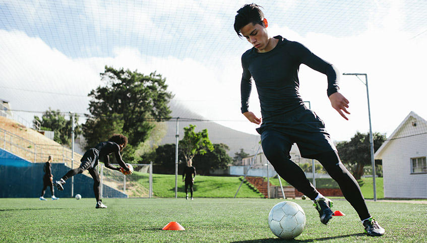 Teen playing soccer