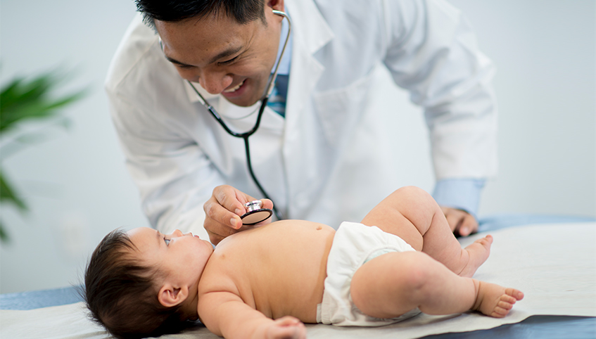 Doctor checking baby's heartbeat. 
