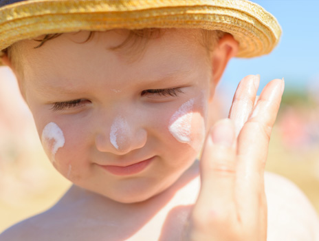 Applying sunscreen to child