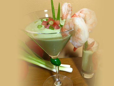 Avocado soup with shrimp in a cocktail glass.
