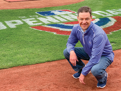 Toby Cook crouching on the field at Kauffman Stadium