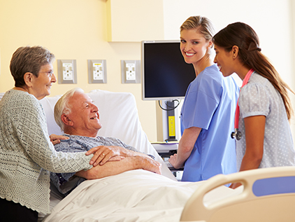 Doctor and nurse meeting with patient in hospital.