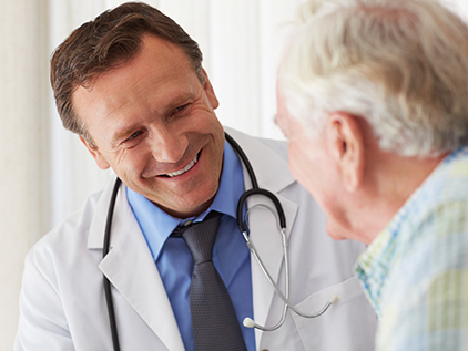 Doctor smiling while talking with patient.