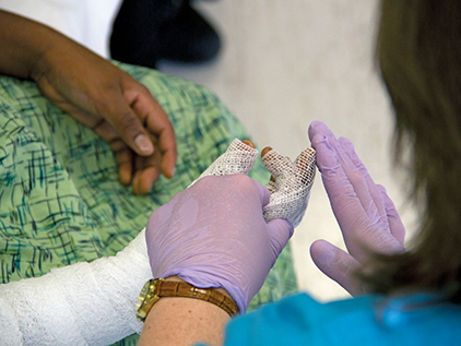 Nurse tending to patient burn