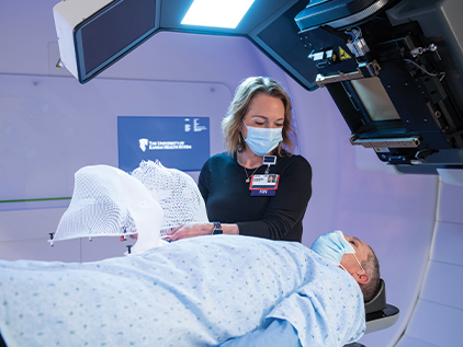 Proton therapy nurse preparing patient for treatment