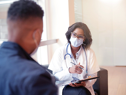 Person sitting with a doctor receiving a second opinion