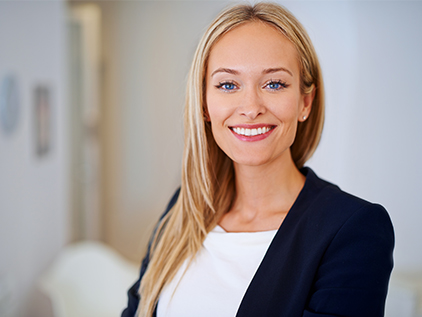 Woman dressed in business professional clothing.