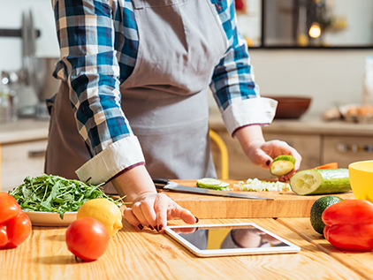 Woman watching recipe video while cooking