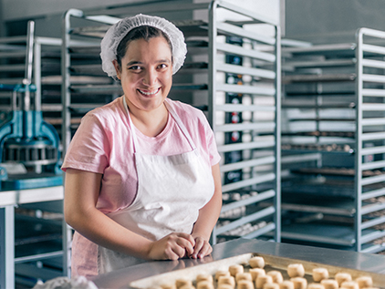 Food services employee prepping food.