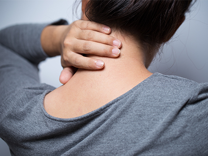 Woman holding her neck in discomfort.