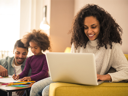 Woman on laptop utilizing online health system resources.