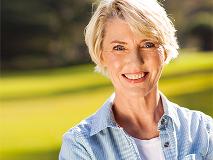 Woman smiling outside.