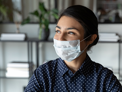 Happy woman wearing a mask.