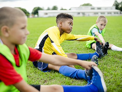 Youth soccer players stretching.