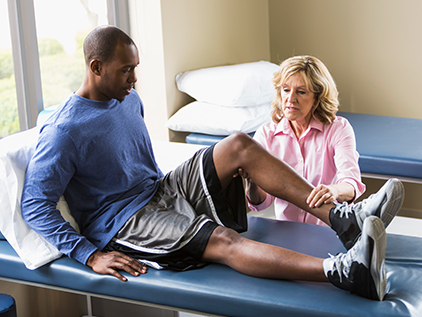 Patient having his knee examined. 