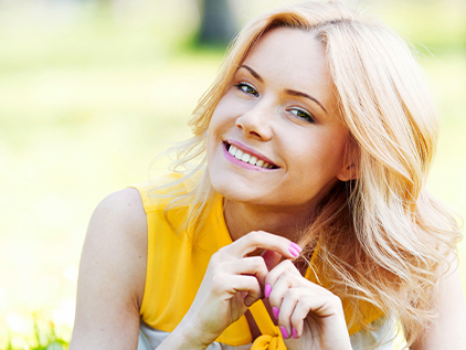 Happy woman laying in the grass.