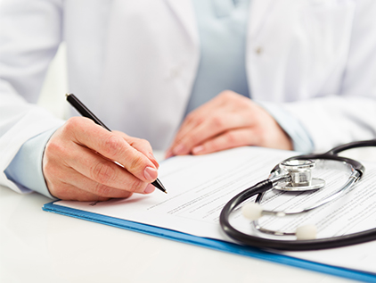 Doctor filling out patient's paperwork.
