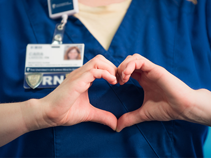 Nurse's hands in the shape of a heart.
