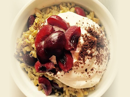 Freekeh bowl with cherries and greek yogurt.