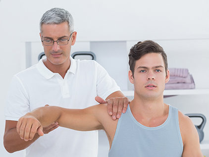Doctor working on patients arm.