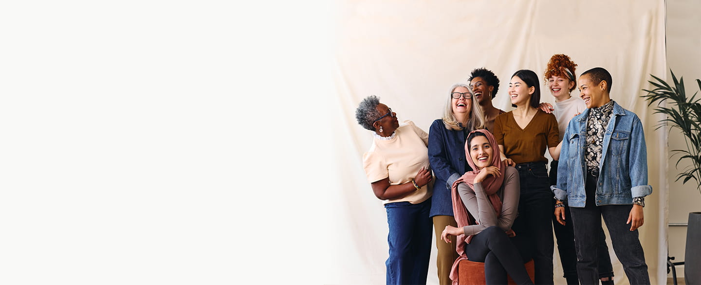 Group of diverse women posing together smiling