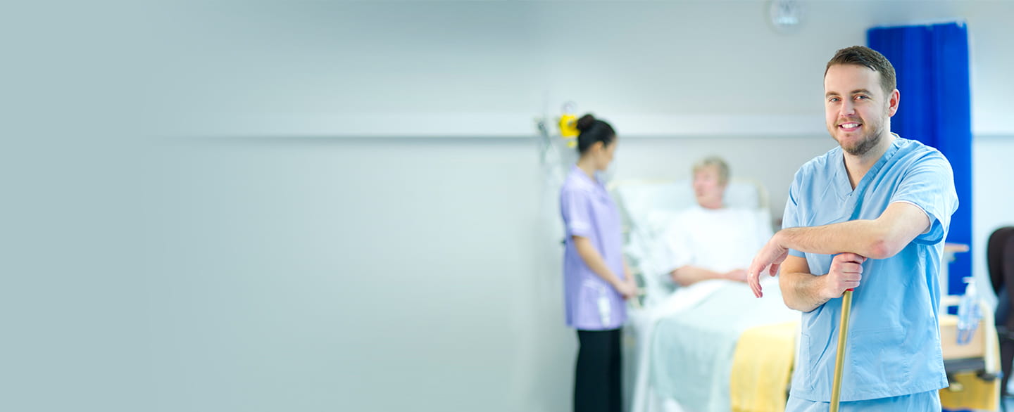 Hospital janitor smiling.