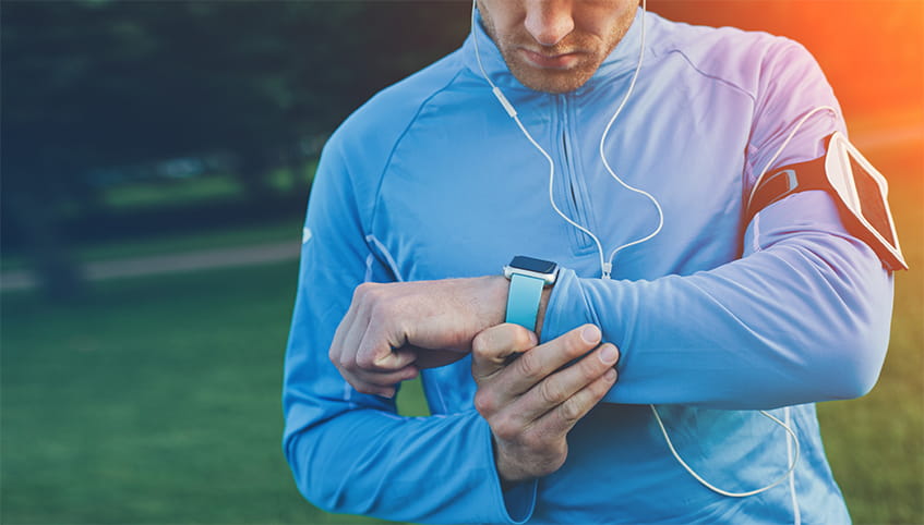 Athlete checking his smart watch.