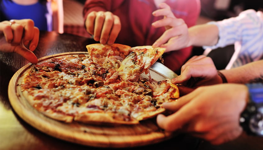 Group of friends eating pizza.