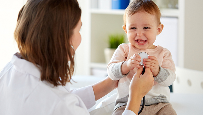 Doctor and smiling child with a stethoscope