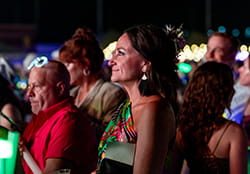 woman in the foreground of a crowd smiling