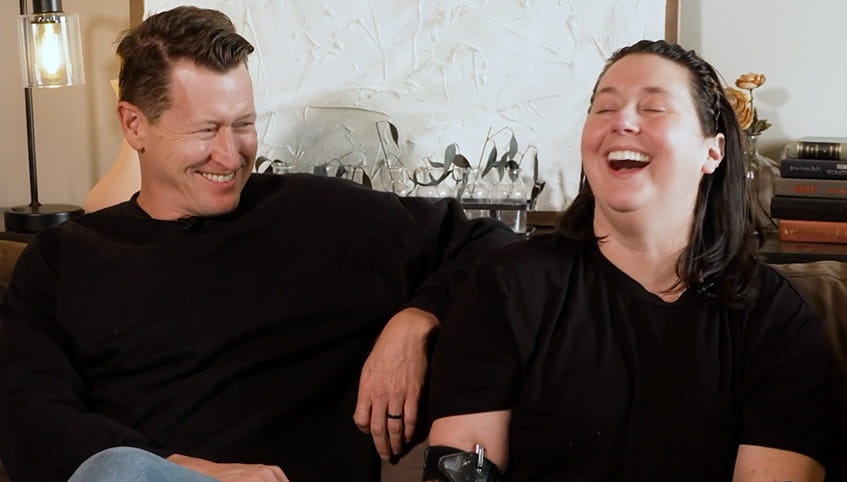 Brie sitting on the couch laughing