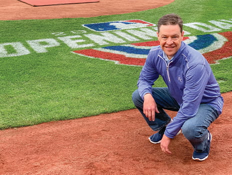 Toby Cook crouching on the field at Kauffman Stadium