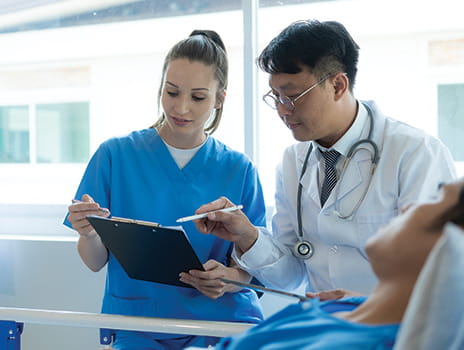 doctor and nurse looking at a patient chart