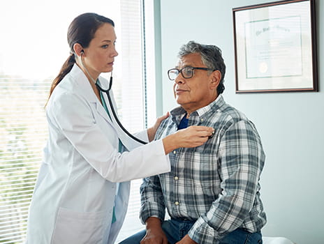 Doctor listening to patient heartbeat