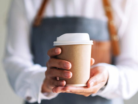 Person holding coffee cup