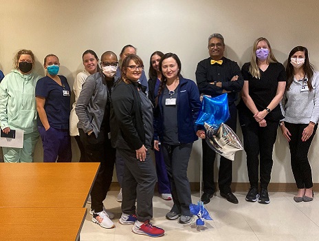 Viktoria Siegert, standing in front holding balloons, celebrates her RFTS scholarship with members of the Landon Center for Aging.