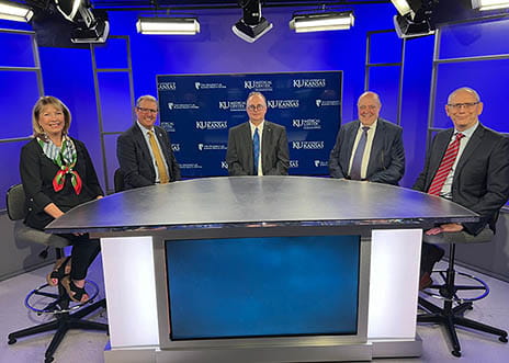 Five leaders from The University of Kansas Health System and the University of Kansas Medical Center sitting around a table facing forward.