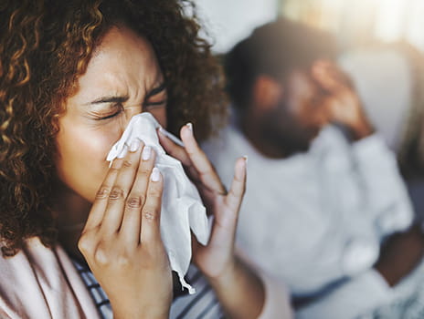 Woman blowing her nose