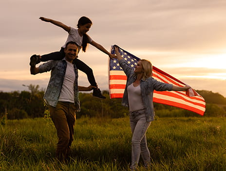 Family celebrating with a flag of the United States of America