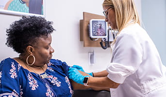 Doctor rolling up the sleeve of a patient